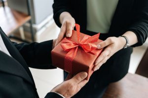 handing gift box to employee