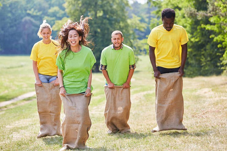 colleagues playing sack jumping game